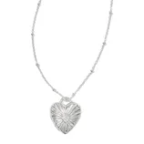 A necklace with a heart-shaped pendant featuring a sunburst design and a small central gem detail, attached to a delicately beaded chain.