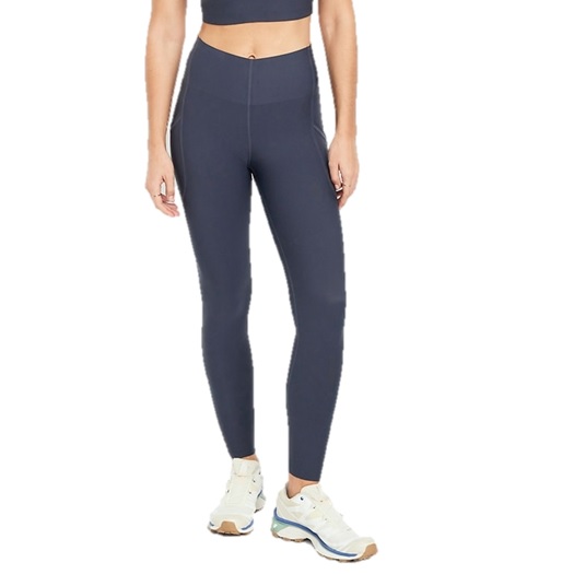 A person is wearing high-waisted, dark gray leggings paired with white athletic sneakers. The outfit includes a matching cropped top.