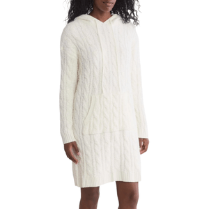 The Hooded Lounge Dress is a soft, cable-knit sweater dress in a creamy white color, featuring long sleeves, a drawstring hood, and a front kangaroo pocket.