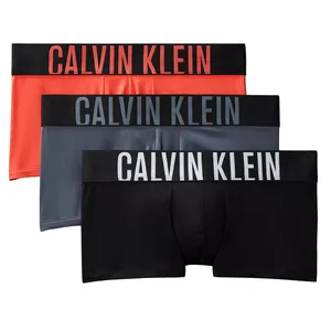 Three pairs of Calvin Klein men's boxer briefs in red, gray, and black, each featuring a black waistband with the brand's logo in varying colors.
