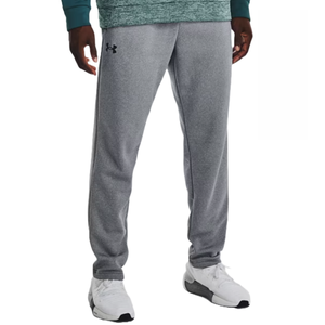 Gray sweatpants with a logo on the left thigh, paired with white sneakers.