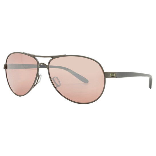 Aviator sunglasses with a metal frame and pink-tinted lenses, featuring the Oakley logo on the temples.