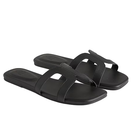 Black slide sandals with two thick straps featuring a cut-out design.