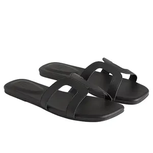 Black slide sandals with two thick straps featuring a cut-out design.