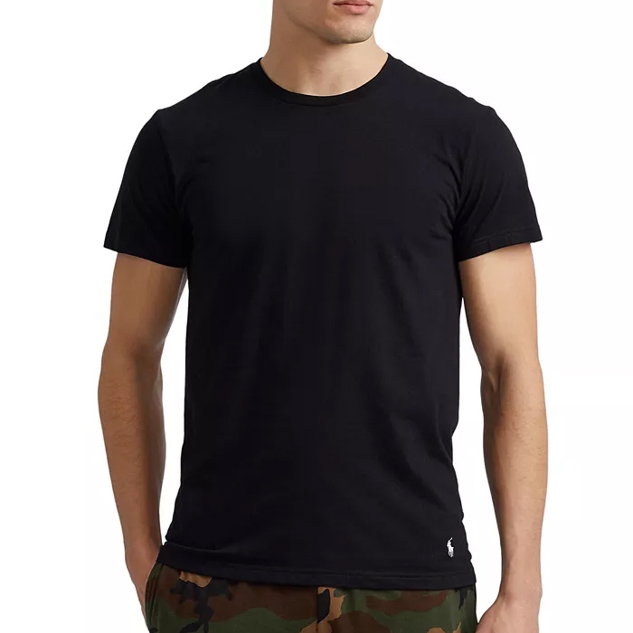 A man is wearing a plain black t-shirt paired with camouflage pants.