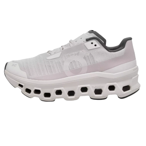 White athletic shoe with a breathable mesh upper and distinctive cloud-like cushioning on the sole, featuring hexagonal cutouts for enhanced flexibility and support.