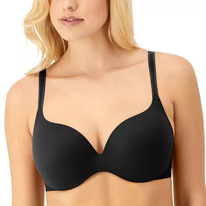 A woman wearing a black underwire bra with thin adjustable straps and smooth, seamless cups.