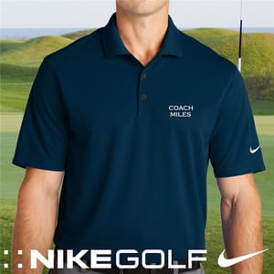 A blue Nike Golf polo shirt with \“Coach Miles\“ embroidered on the chest, featuring the Nike logo on the sleeve, set against a golf course background.