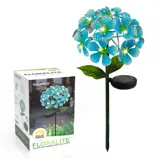 Solar LED garden decor light in the shape of blue flowers with a stake for outdoor installation and a solar panel for power, alongside its packaging box.
