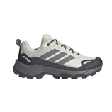 Adidas Terrex hiking shoe featuring a light gray upper, gray accents, and a rugged black sole designed for outdoor use.