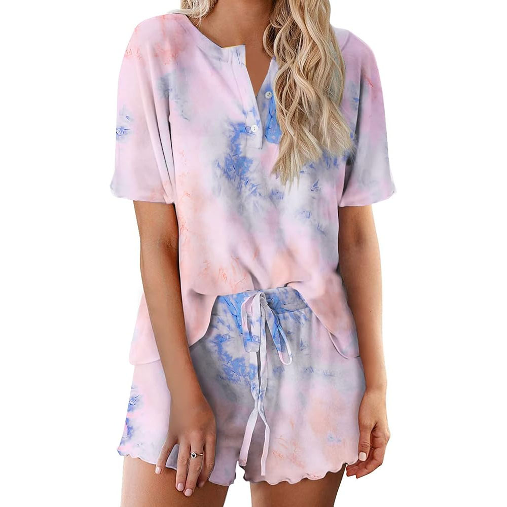 A short-sleeved, button-down tie-dye lounge set featuring a top with a round neckline and matching shorts with a drawstring waist. The set displays a soft blend of pastel colors, including pink and blue.