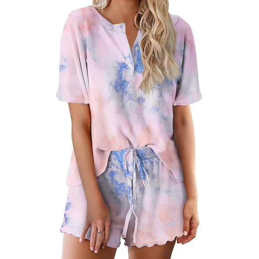 A short-sleeved, button-down tie-dye lounge set featuring a top with a round neckline and matching shorts with a drawstring waist. The set displays a soft blend of pastel colors, including pink and blue.