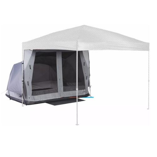 A gray tent is set up under a large white canopy, providing additional shelter and space.