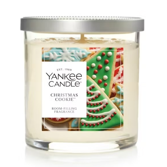 Yankee Candle \“Christmas Cookie,\“ a two-wick, fragrant candle featuring festive cookie designs on the label, with a metallic lid.