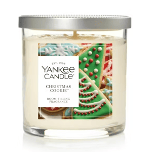 Yankee Candle \“Christmas Cookie,\“ a two-wick, fragrant candle featuring festive cookie designs on the label, with a metallic lid.