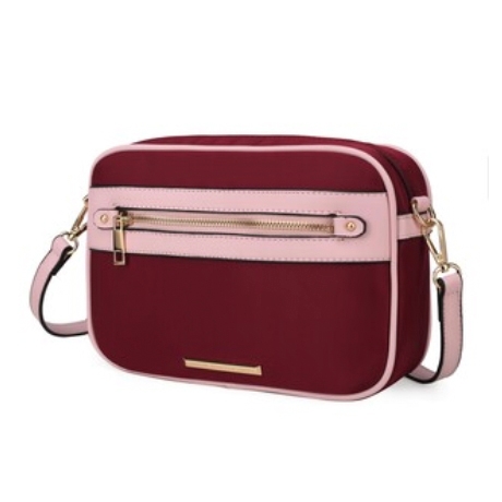 A shoulder bag with a burgundy body and pink accents, featuring a front zipper pocket, detachable pink strap, and gold-tone hardware.