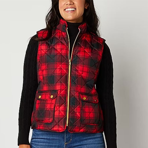 Woman wearing a red and black plaid vest.