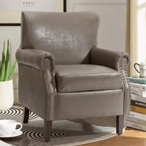Gray faux leather armchair with nailhead trim and wooden legs, featuring a high back and cushioned seat for a classic look.