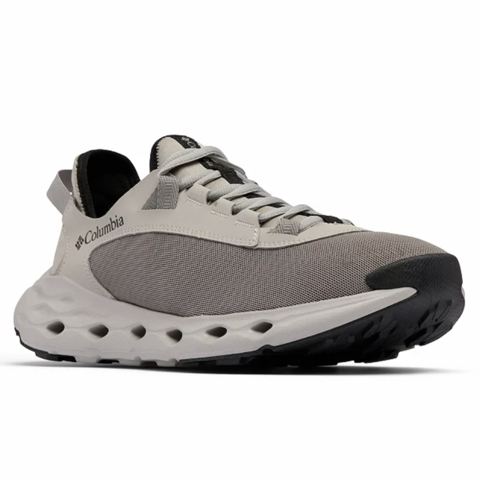 Columbia sneaker featuring a grey mesh upper, reinforced with leather overlays, a cushioned midsole with circular cutouts, and black rubber sole.