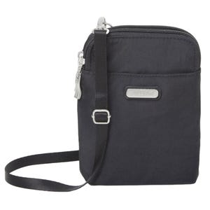 A compact black crossbody bag with a zipper closure and adjustable strap, featuring a metal logo plate on the front.