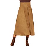 A brown midi-length skirt with a slight A-line cut paired with brown leather boots.