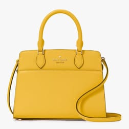 A yellow Kate Spade handbag with top handles and a detachable shoulder strap, featuring a logo on the front.