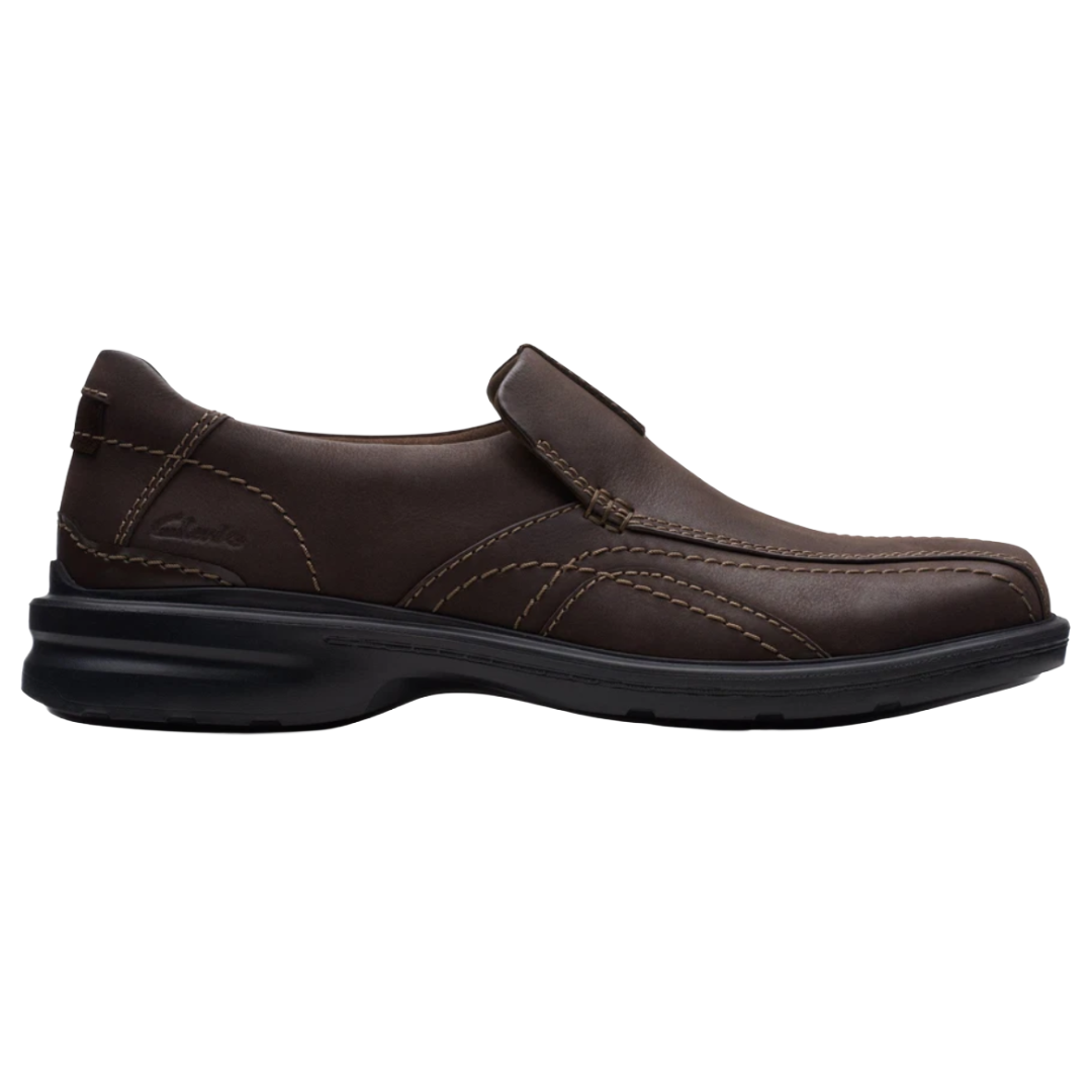 Brown slip-on shoe with contrast stitching and a black sole, featuring the Clarks logo.