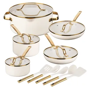 A cookware set with gold-accented handles includes a stockpot, two saucepans, two frying pans with lids, and four white utensils featuring matching gold-tone handles.