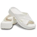 White Crocs Classic Cross Strap Sandals with a textured footbed and slip-on design, featuring two wide, overlapping straps with holes for breathability, and the Crocs logo on the side of the heel.