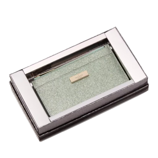A light green glitter zippered pouch with a metal label is housed in a metallic rectangular display box.
