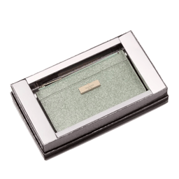 A light green glitter zippered pouch with a metal label is housed in a metallic rectangular display box.