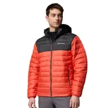 A man is wearing a Columbia jacket with a red quilted body and black shoulder and hood. It features a front zipper and side pockets.