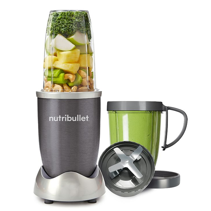 A NutriBullet blender with a filled blending cup, an extra handled cup, and a detachable blade assembly, all in a silver and black color scheme.