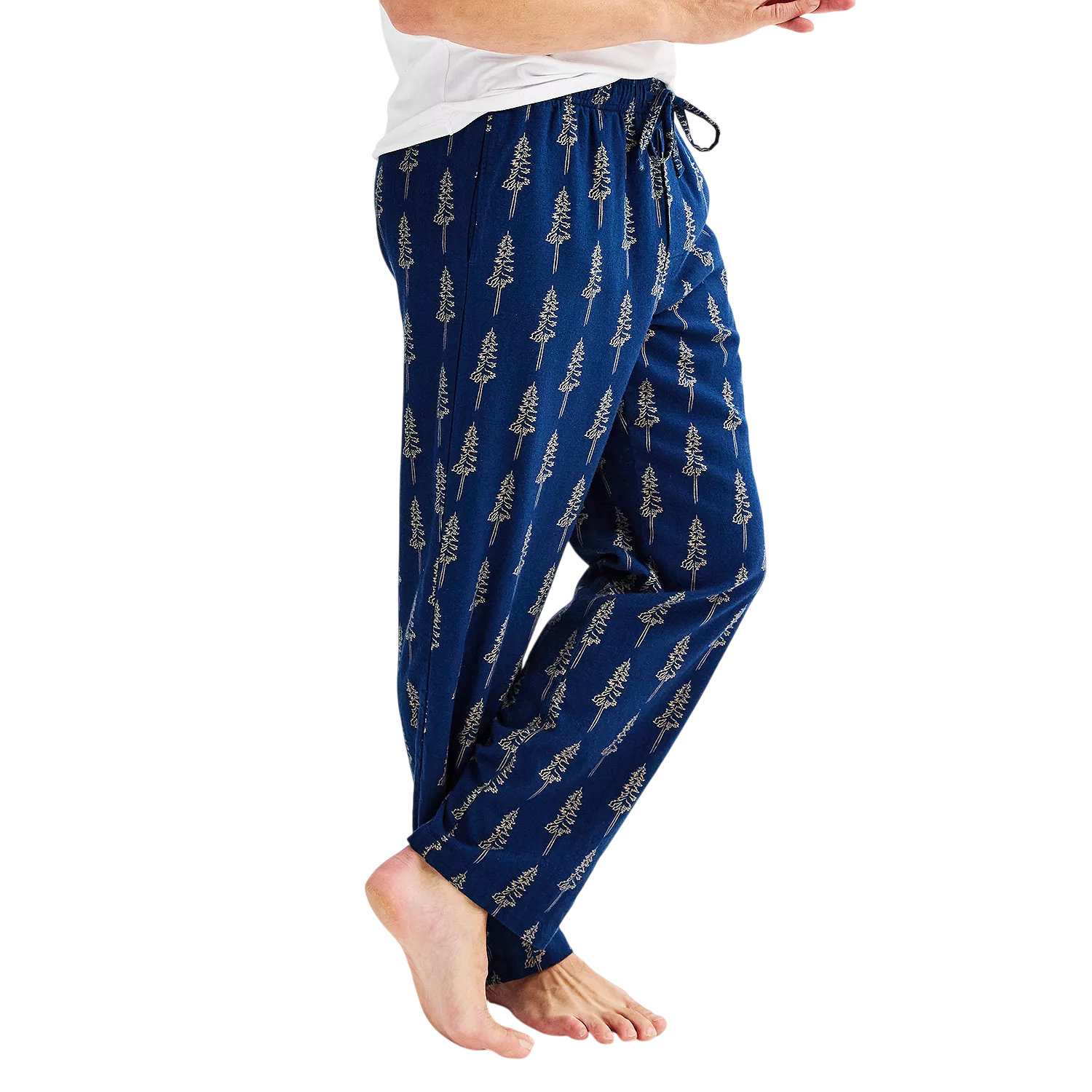 Blue pajama pants with drawstring waist, featuring a pattern of trees. Paired with a white shirt, worn by a person standing barefoot.