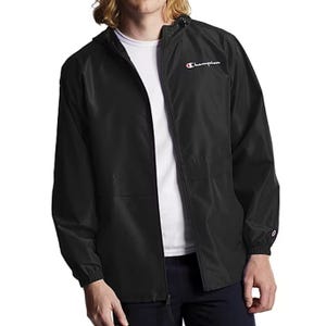 Black Champion windbreaker jacket featuring a hood, full zip closure, elastic cuffs, and the Champion logo on the chest and sleeve.