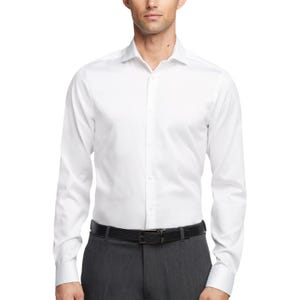 A man is wearing a white, long-sleeve dress shirt paired with gray pants and a black belt.