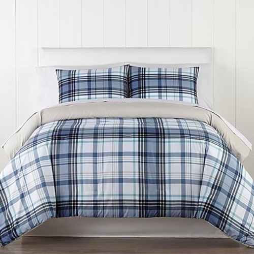A blue and white plaid bedding set, including a comforter and two matching pillow shams, displayed on a neatly made bed.