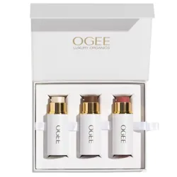 A box containing three cylindrical tubes labeled \“OGEE LUXURY ORGANICS,\“ each with a gold cap. The tubes are neatly placed in a white box with a lid, designed for a luxury aesthetic.