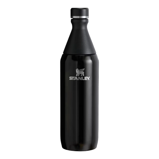 A black Stanley water bottle with a silver logo, featuring a tapered neck and removable cap.