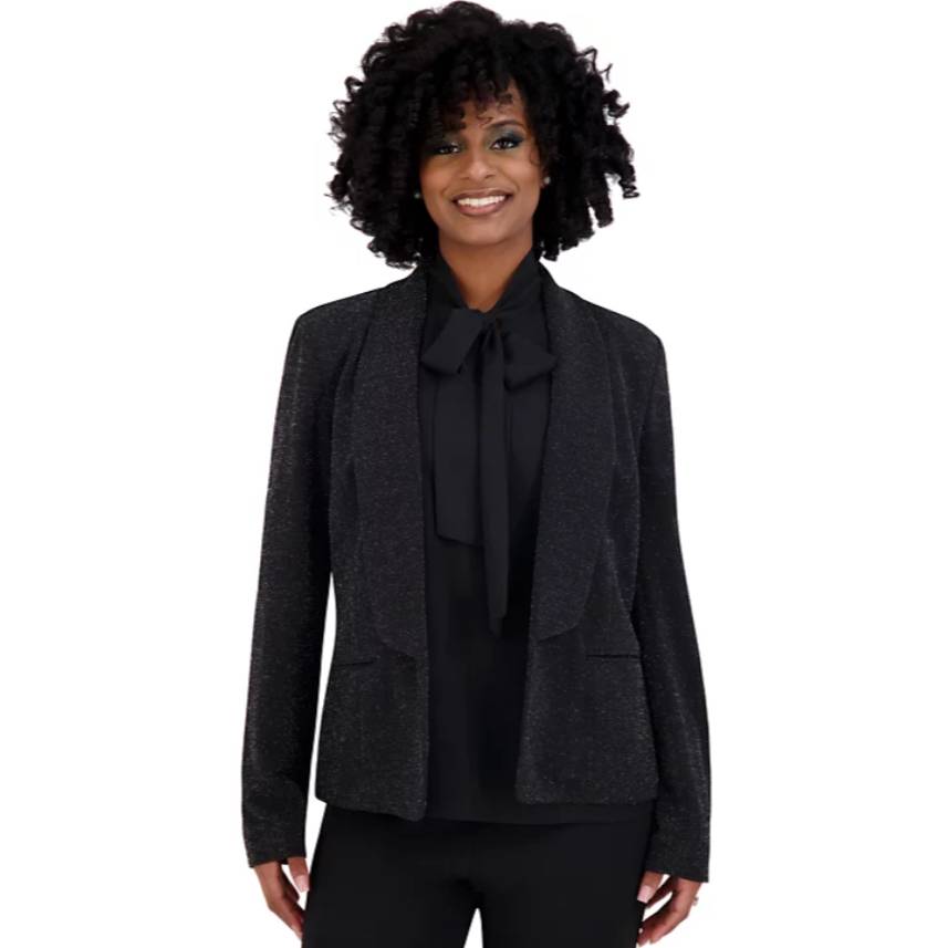 Black glitter jacket with an open front design, featuring a subtle shimmer. It includes a tailored fit with two front pockets, and is paired with a matching black blouse with a bow tie at the neck.
