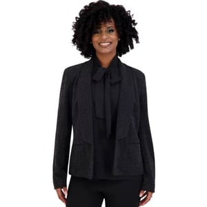 Black glitter jacket with an open front design, featuring a subtle shimmer. It includes a tailored fit with two front pockets, and is paired with a matching black blouse with a bow tie at the neck.
