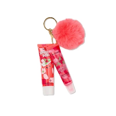 Two tubes of sparkling berry lip gloss with a pink furry keychain attached.