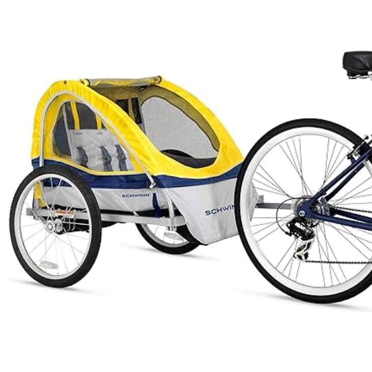 A Schwinn bike trailer with a yellow and blue canopy, designed for attachment to a bicycle. It features a mesh window for ventilation and two wheels for stability, suitable for carrying children or cargo.