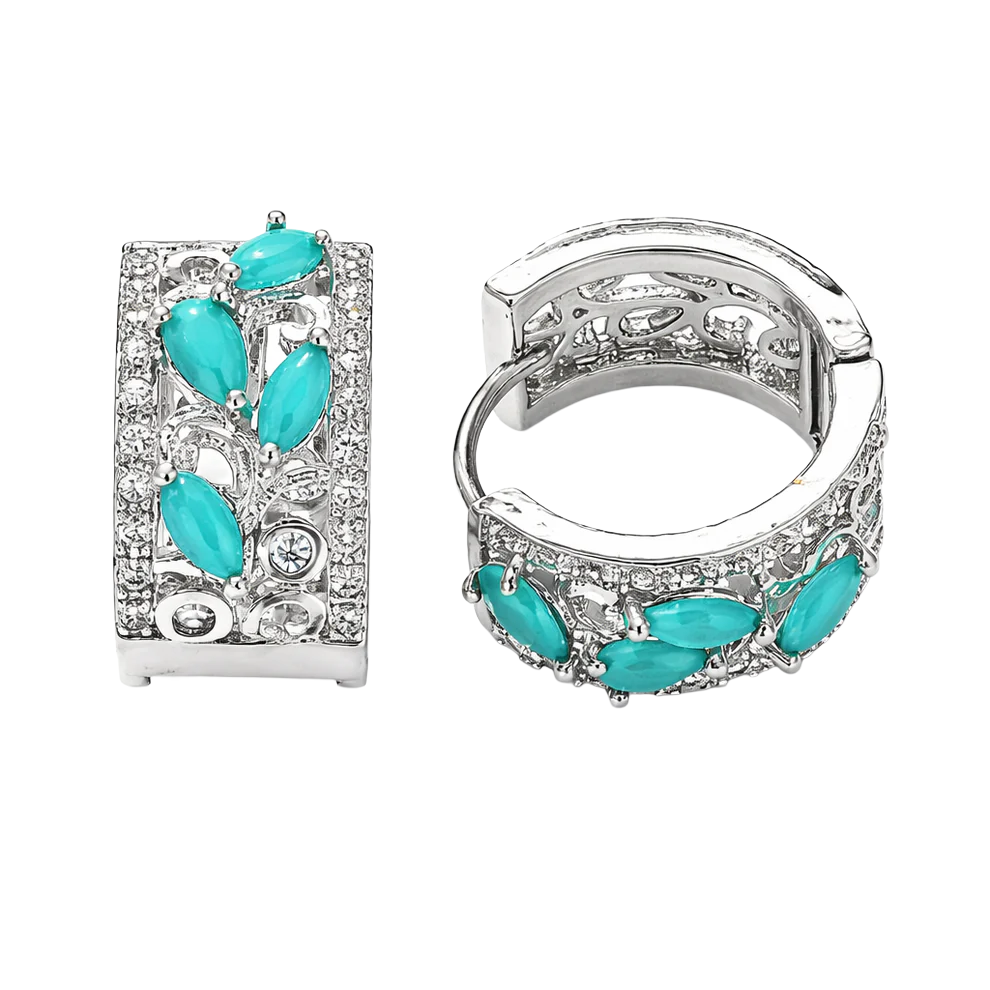 Silver hoop earrings adorned with turquoise marquise-cut stones and small clear crystals in an open filigree design.