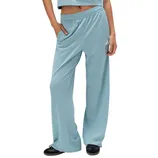 Light blue track pants with a wide-leg design and an Adidas logo, paired with black sneakers.