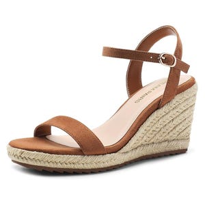 Brown espadrille wedge sandals with a jute-wrapped heel, featuring a single front strap and an adjustable ankle strap with a buckle closure.