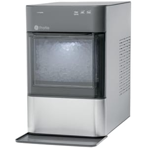 A stainless steel GE Profile ice maker with a transparent front display showing nugget ice. Control buttons are on the top edge, including options for clean, light, and power.