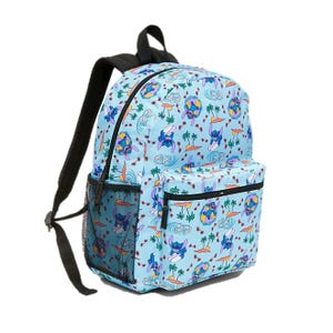 A light blue backpack featuring a colorful, cartoony pattern with surfing scenes and tropical elements. It has a front zipper pocket and side mesh pocket.