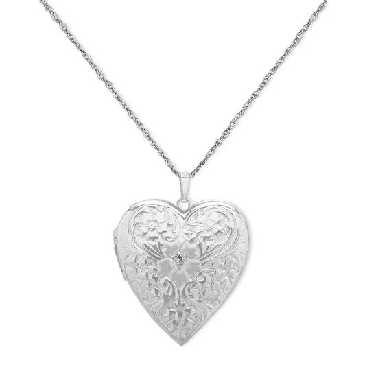 Heart-shaped silver-tone locket with an ornate floral design, hanging from a delicate chain.