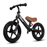 A black balance bike with a brown saddle, black handlebars, and thick black tires, featuring a small decorative flower detail.